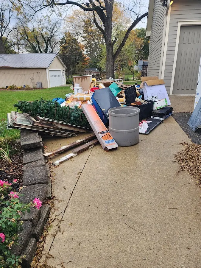 Dumpster being loaded with debris for 12 Yard Dumpster Rental in Greenfield